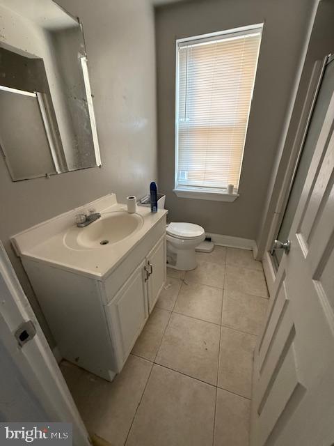 bathroom with tile patterned floors, vanity, and toilet