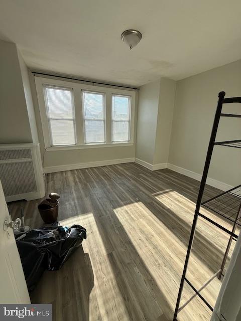 bedroom with hardwood / wood-style floors