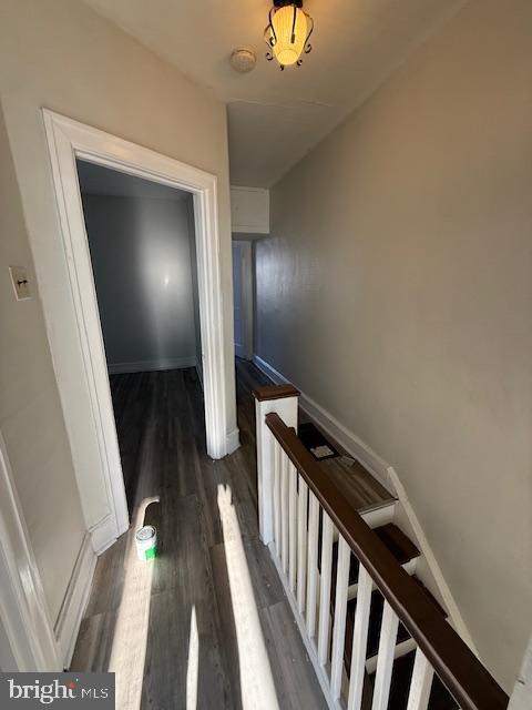 hallway with dark hardwood / wood-style floors