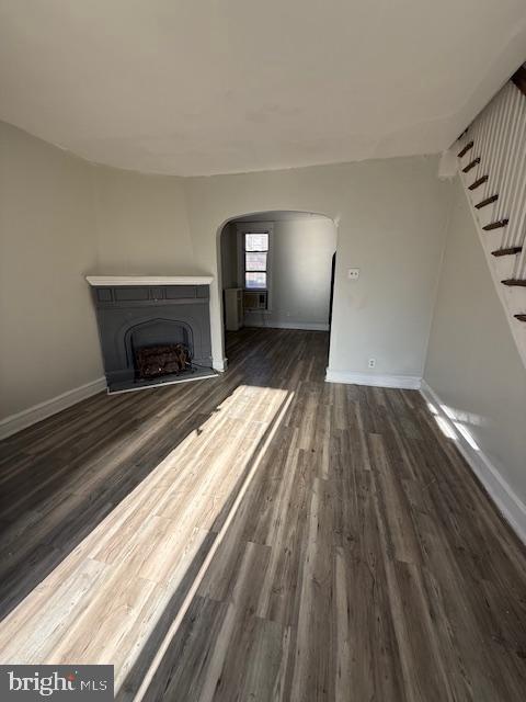 unfurnished living room featuring dark hardwood / wood-style flooring