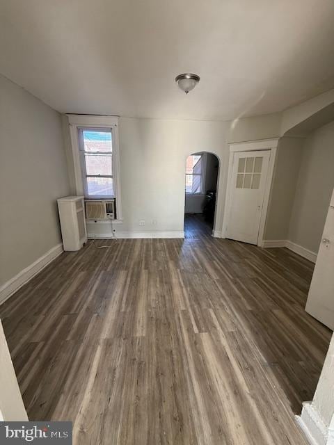 unfurnished living room featuring dark hardwood / wood-style floors and cooling unit