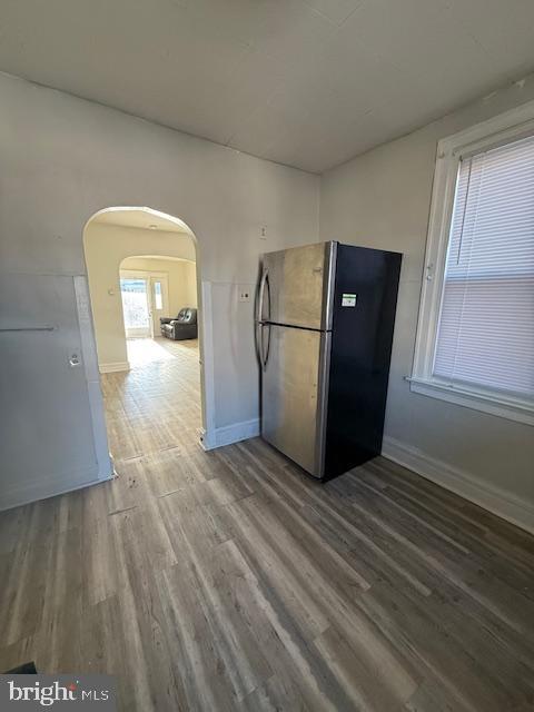 kitchen with hardwood / wood-style flooring and stainless steel refrigerator