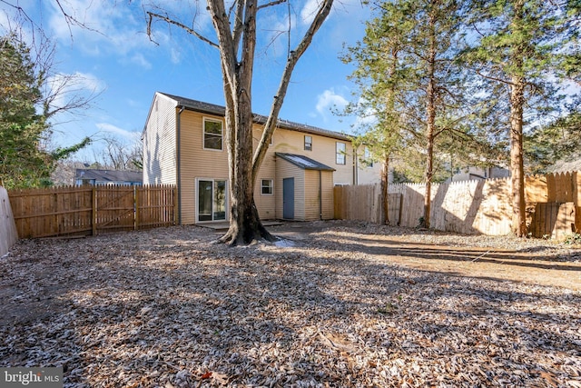 rear view of property featuring a shed