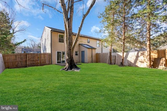 back of property with a yard and a storage shed