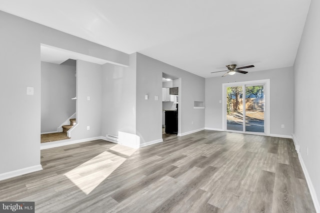 unfurnished living room with ceiling fan and light hardwood / wood-style floors