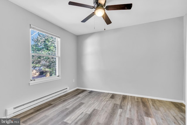 empty room with ceiling fan, light hardwood / wood-style flooring, and a baseboard heating unit