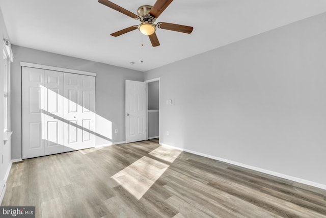 empty room with light wood-type flooring and ceiling fan