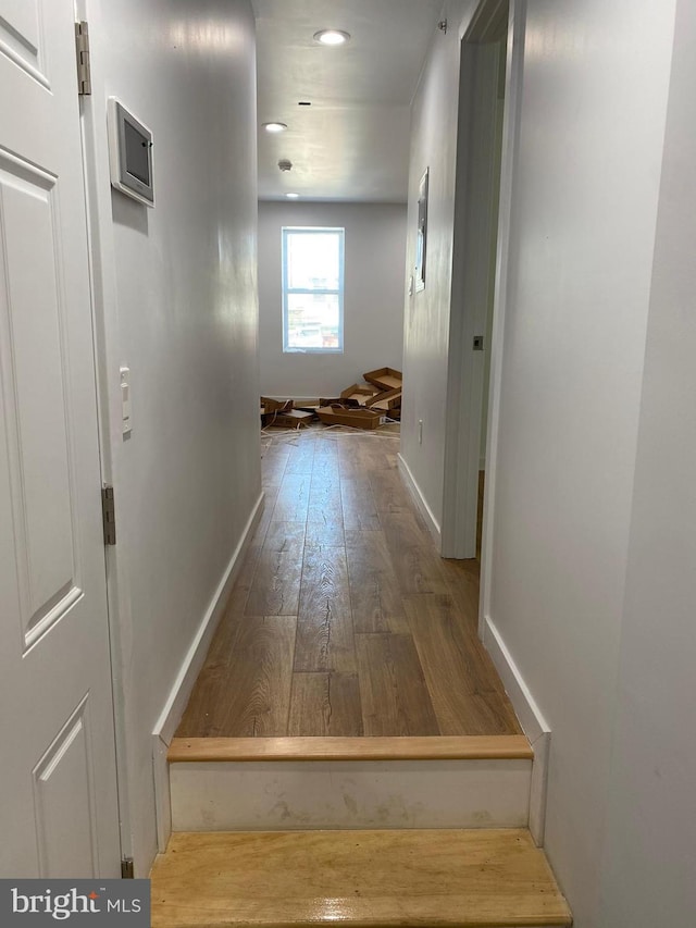 hallway with hardwood / wood-style floors