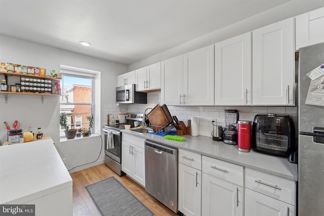 kitchen with white cabinets, light countertops, and appliances with stainless steel finishes