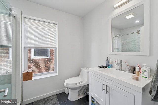 bathroom featuring tile patterned flooring, vanity, toilet, baseboards, and walk in shower