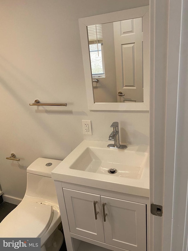 bathroom with vanity and toilet