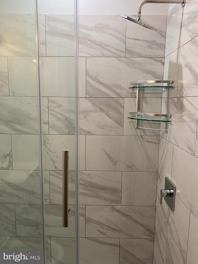 bathroom with a shower with door