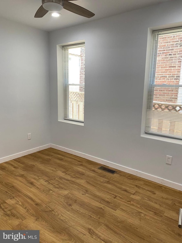 spare room featuring hardwood / wood-style floors and ceiling fan