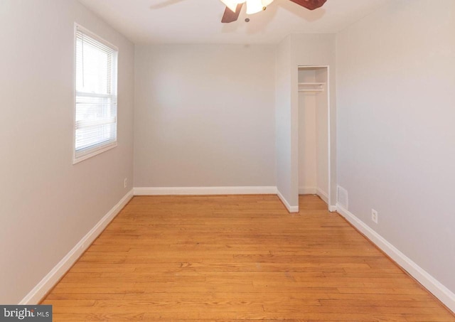 spare room featuring light wood-type flooring and ceiling fan