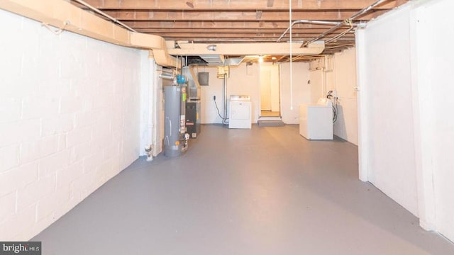 basement featuring washer / clothes dryer and water heater