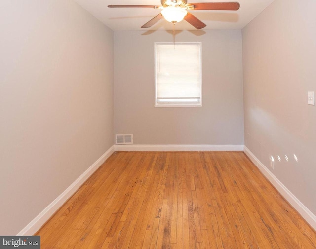 spare room featuring light wood-type flooring and ceiling fan