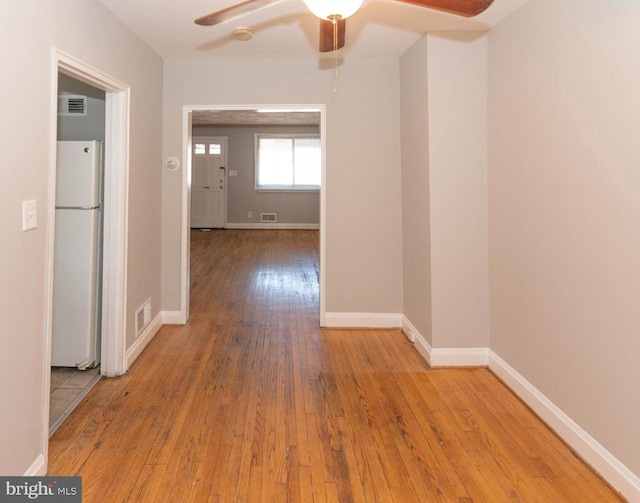 hallway with light hardwood / wood-style floors