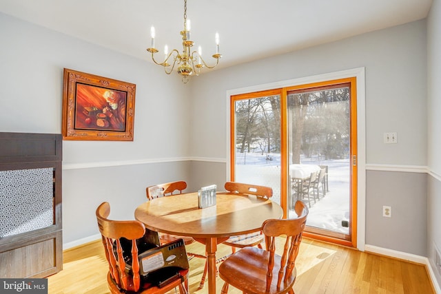 dining area with a chandelier and light wood-type flooring