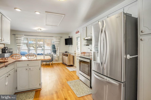 kitchen featuring white cabinets, light hardwood / wood-style floors, and stainless steel appliances