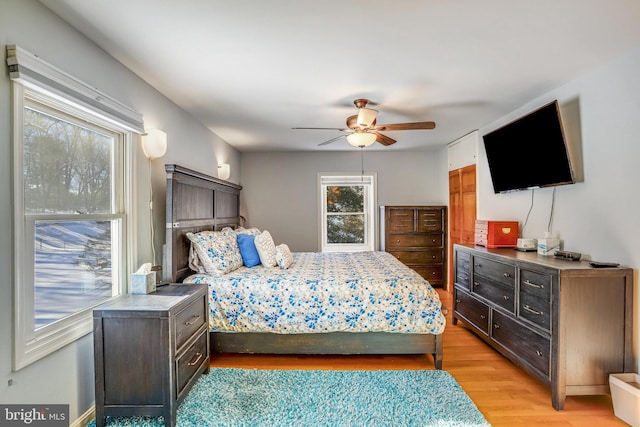 bedroom with ceiling fan and light hardwood / wood-style flooring