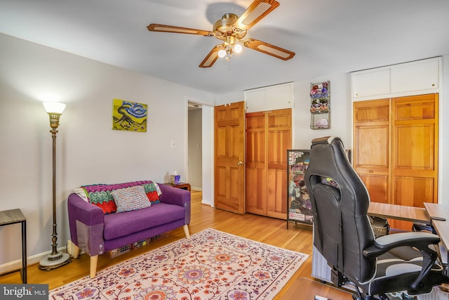 home office featuring ceiling fan and light hardwood / wood-style floors