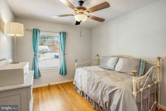 bedroom with ceiling fan and light hardwood / wood-style floors