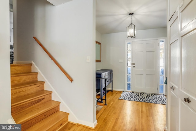 entrance foyer featuring a notable chandelier and light wood-type flooring