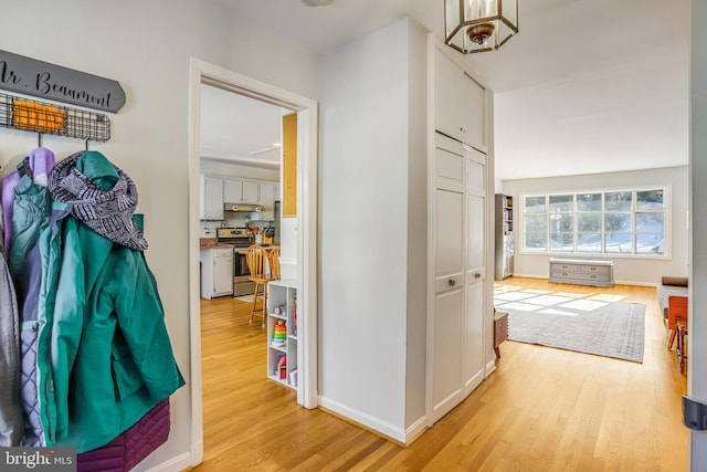 corridor with light hardwood / wood-style flooring