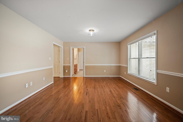 empty room with hardwood / wood-style floors