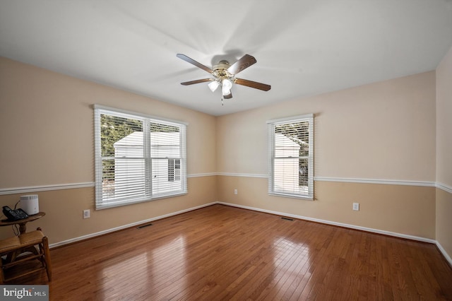 empty room featuring ceiling fan and hardwood / wood-style floors