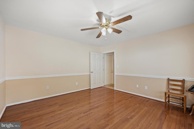 empty room with hardwood / wood-style flooring and ceiling fan