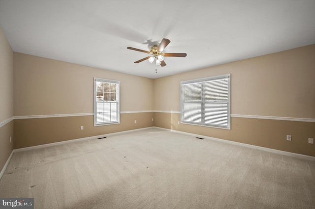 carpeted spare room with ceiling fan