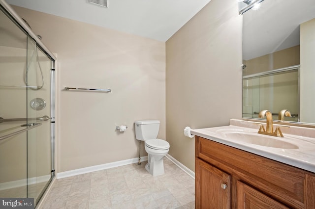 bathroom with walk in shower, vanity, and toilet