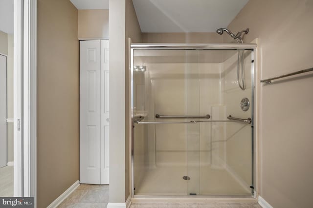 bathroom with a shower with shower door