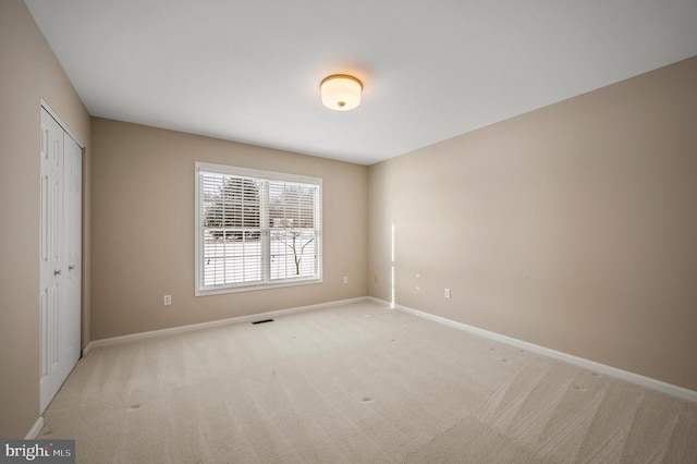 empty room featuring light carpet