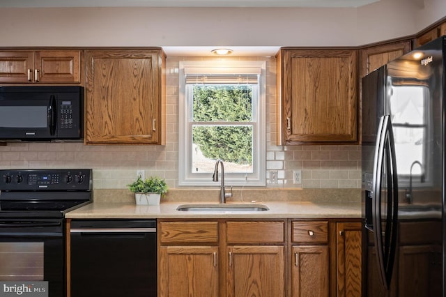 kitchen with sink, backsplash, and black appliances