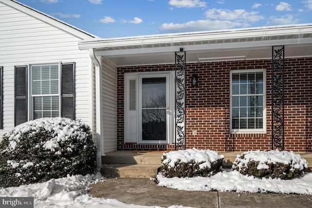 view of snow covered property entrance