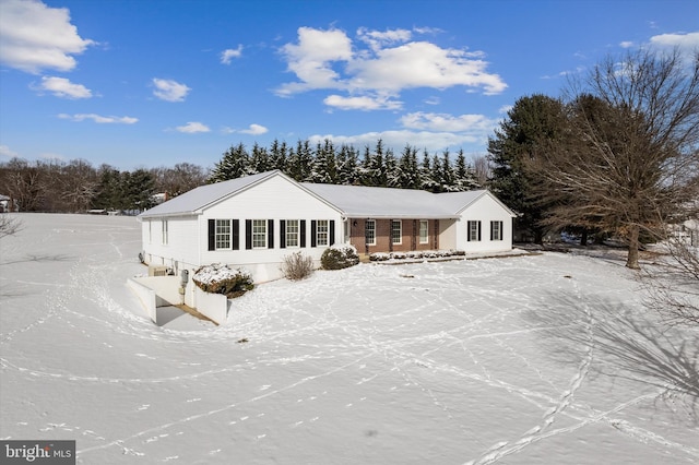 view of snow covered rear of property