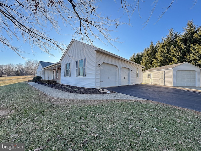 view of side of home with a yard, an outdoor structure, and a garage