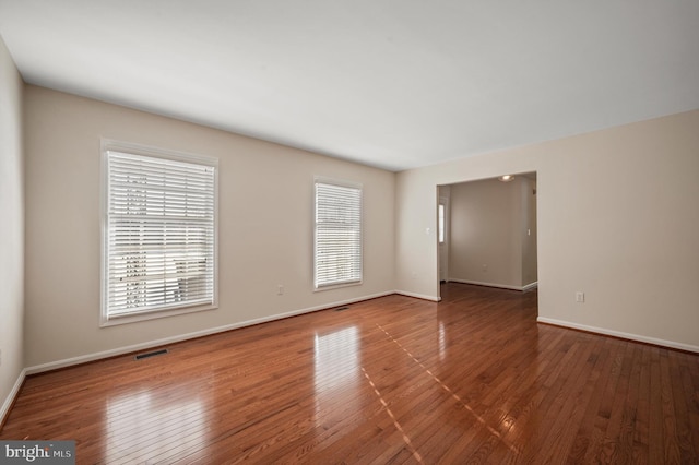 unfurnished room with hardwood / wood-style flooring