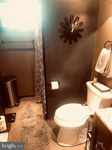 bathroom featuring toilet and vanity