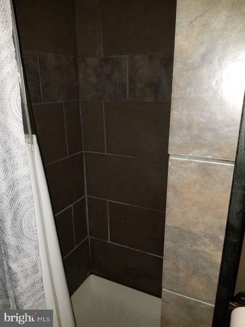 interior details with a tile shower