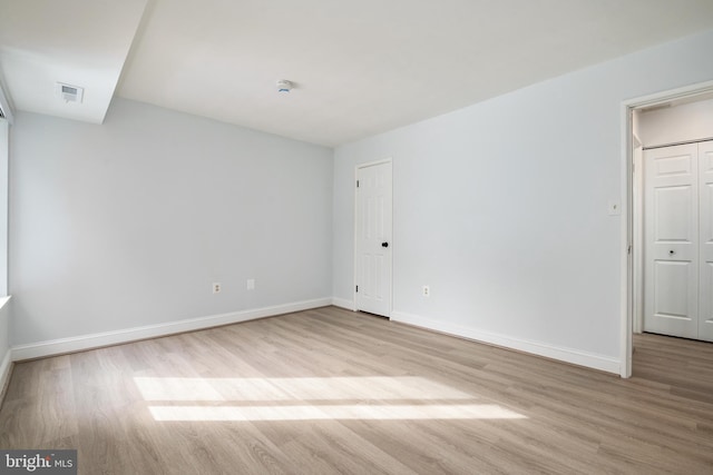 spare room featuring light hardwood / wood-style flooring