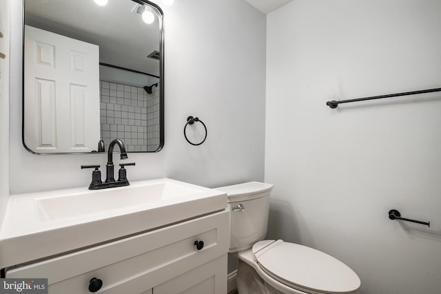 bathroom featuring toilet and vanity