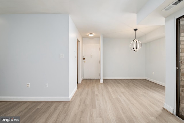 spare room with light hardwood / wood-style flooring