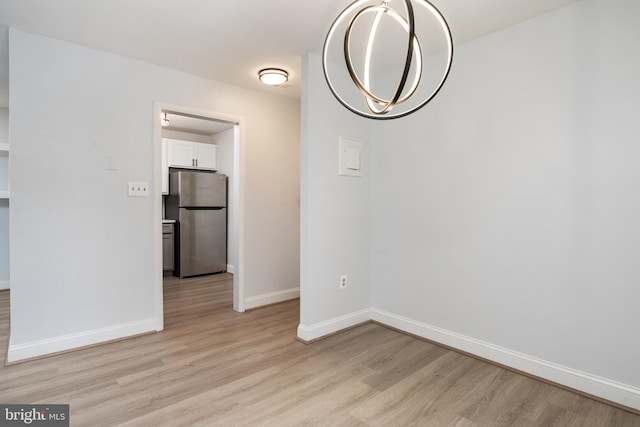 unfurnished dining area featuring light wood-type flooring