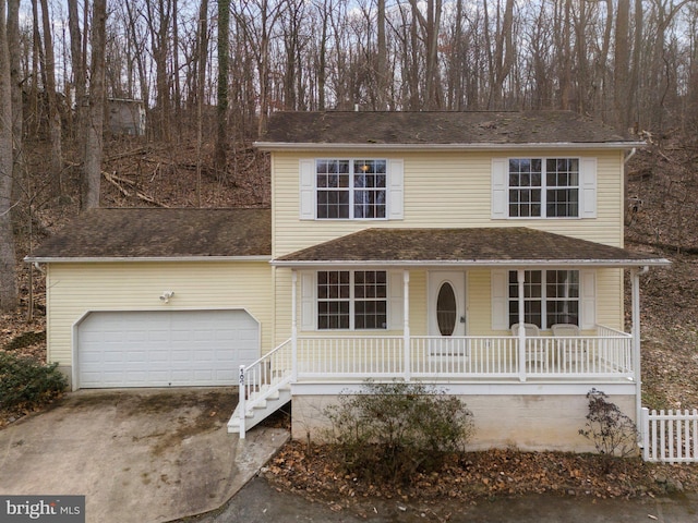 view of property featuring a porch and a garage