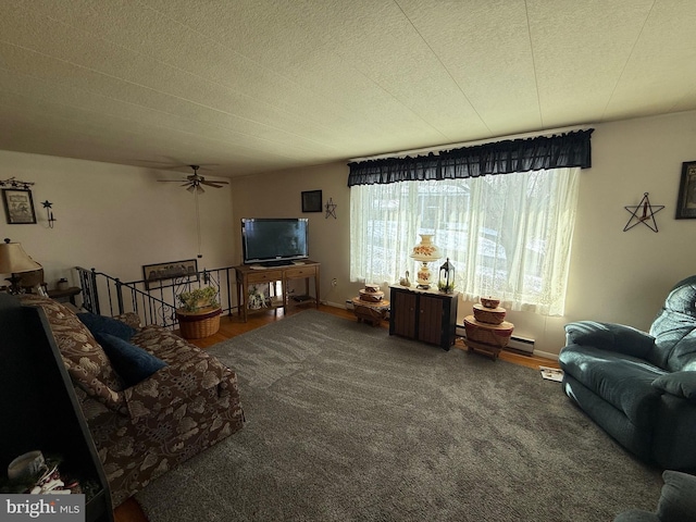 carpeted living room featuring a textured ceiling, baseboard heating, and ceiling fan