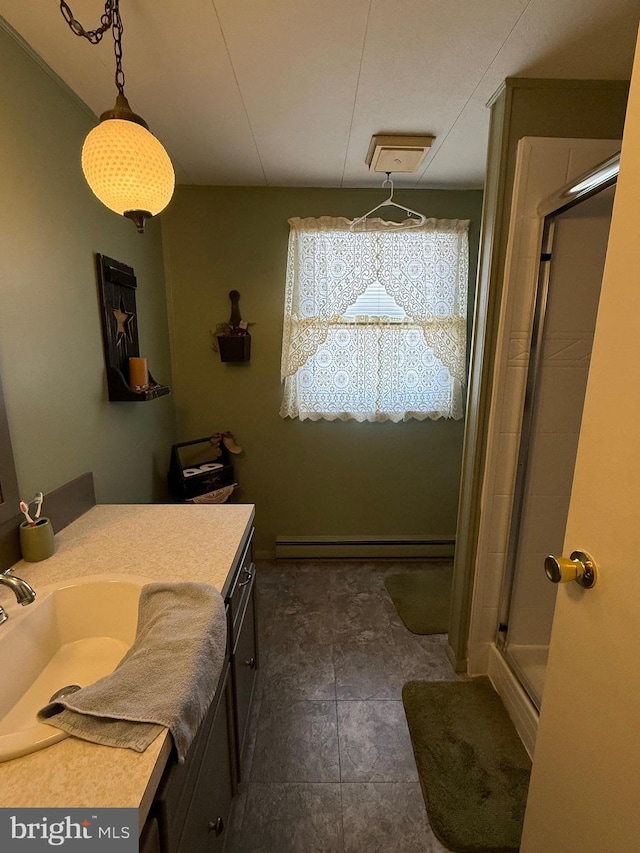 bathroom with a shower with door, vanity, and a baseboard radiator