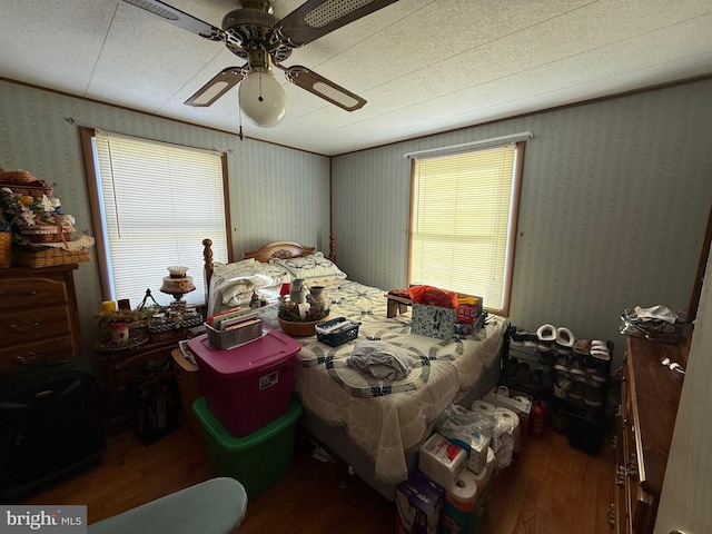 bedroom with ceiling fan and dark hardwood / wood-style flooring